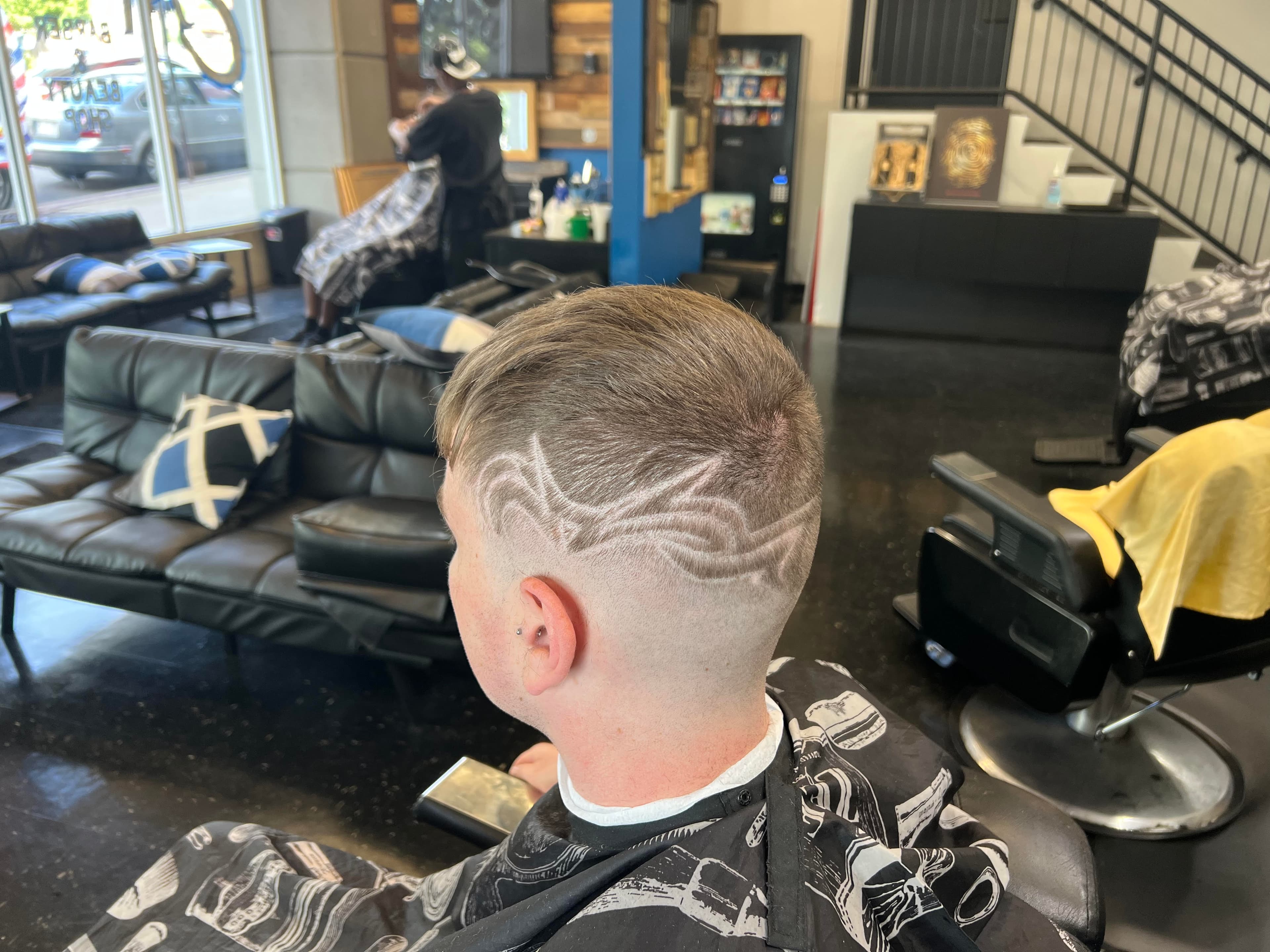 A happy client after a fresh cut at The Experience
